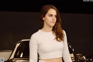 A woman in a black jacket and jeans posing for a picture.