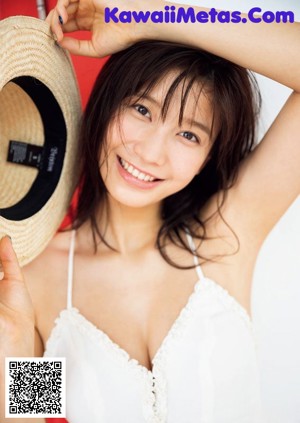 A woman in a black bra and panties leaning against a door.