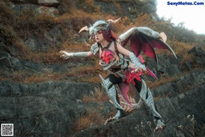 A woman with red hair wearing a dragon mask.