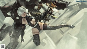 A woman in a black outfit holding a sword.