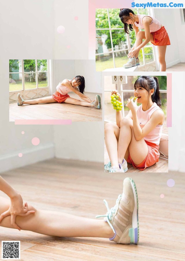 A woman sitting on the floor with a bunch of grapes in her hand.