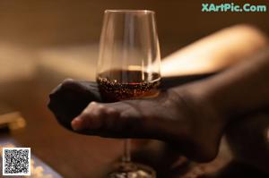 A woman in a black thong and stockings standing in a room.