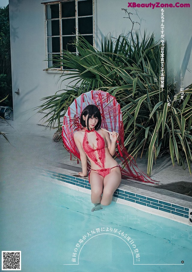 A woman in a red bikini sitting on the edge of a pool.