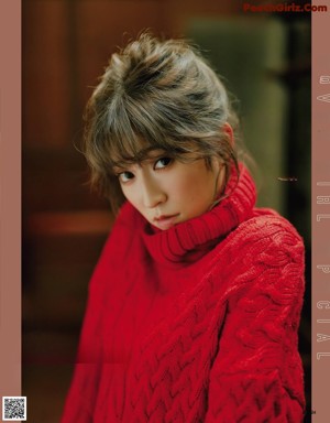 A woman in a white coat is posing for a magazine.