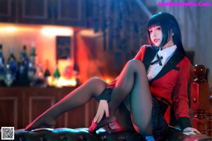 A woman sitting on top of a black leather chair.