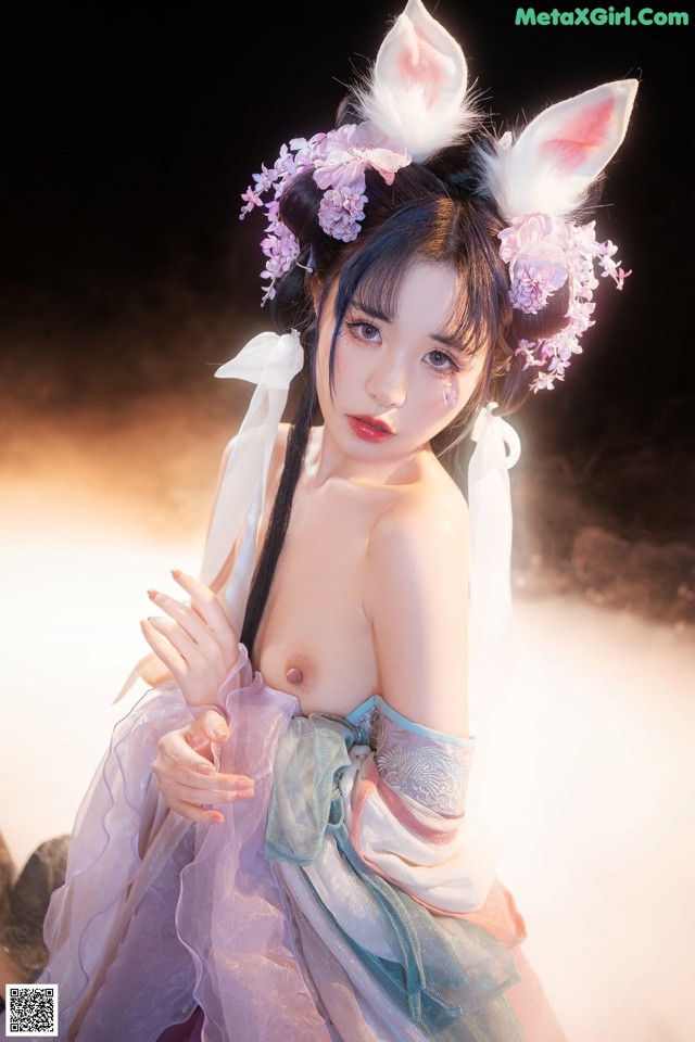 A woman in a bunny costume posing for a picture.