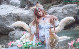 A woman in a white lingerie sitting in the water.